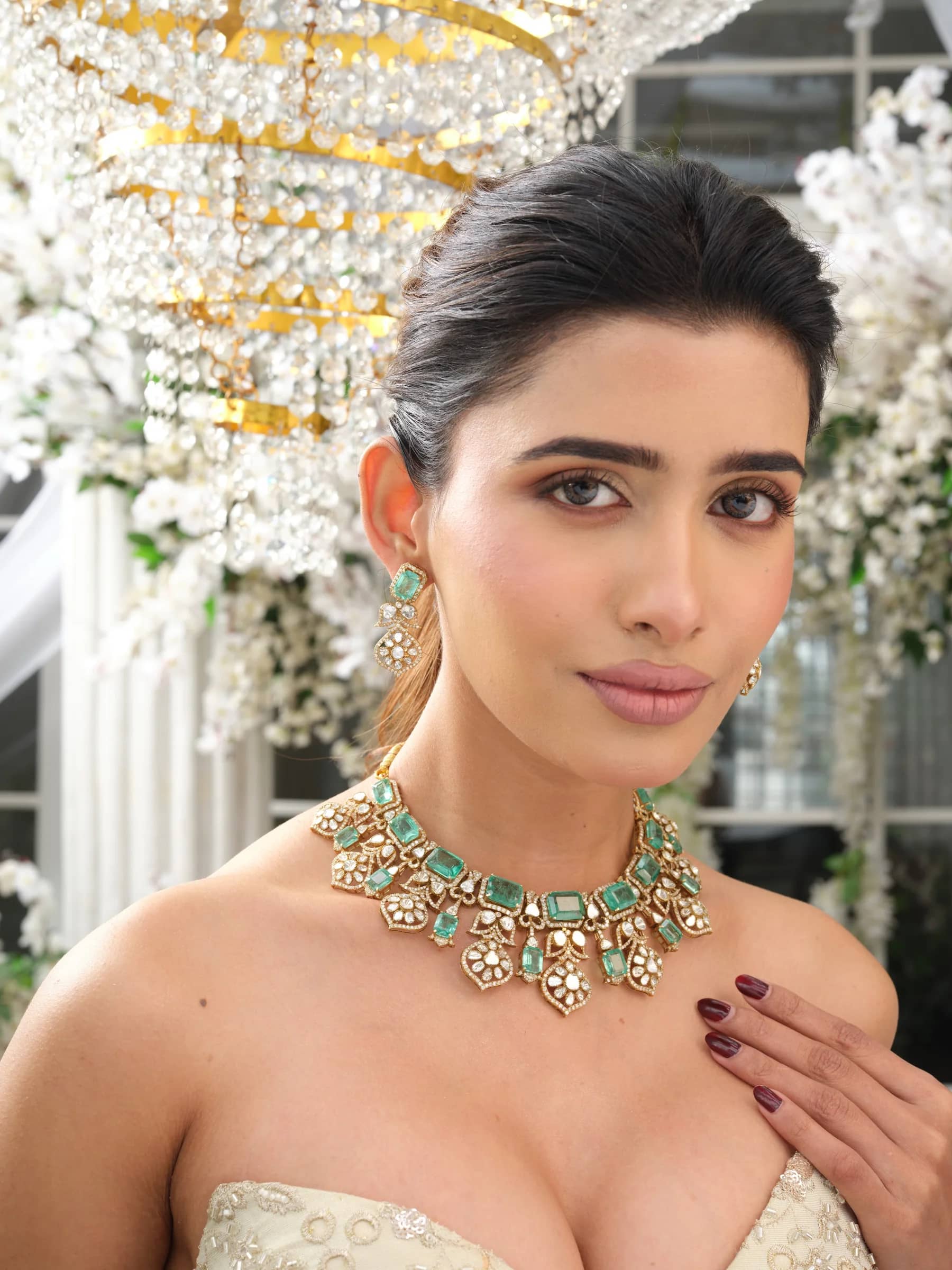 The Inara open-polki choker, beneath the chandelier